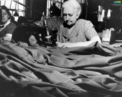 Des femmes travaillent à la confection d’uniformes, pendant la Seconde Guerre mondiale (1939-1945). À Sherbrooke, les manufactures de tissus (Paton, Dominion Textile) et de vêtements (S. Rubin Ltd) reçoivent de telles commandes du gouvernement canadien.